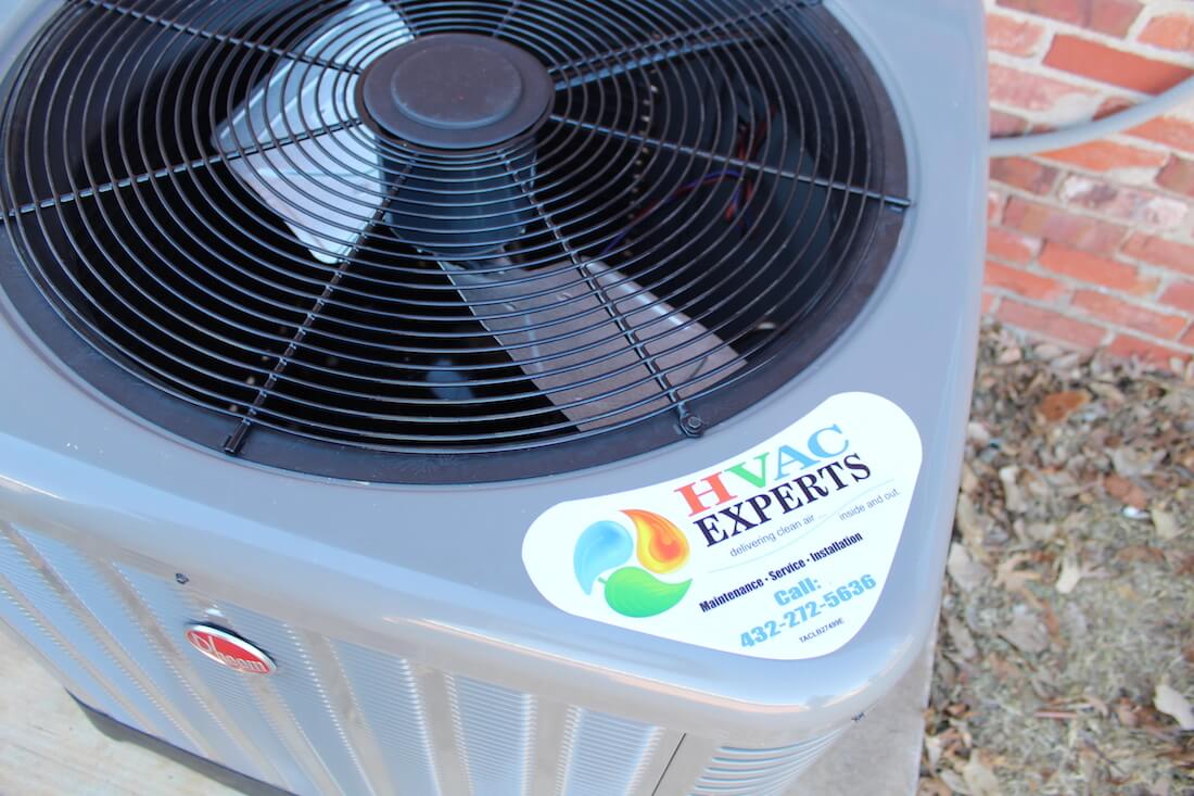 HVAC Experts branded heat pump unit with company logo sticker in Odessa, Texas